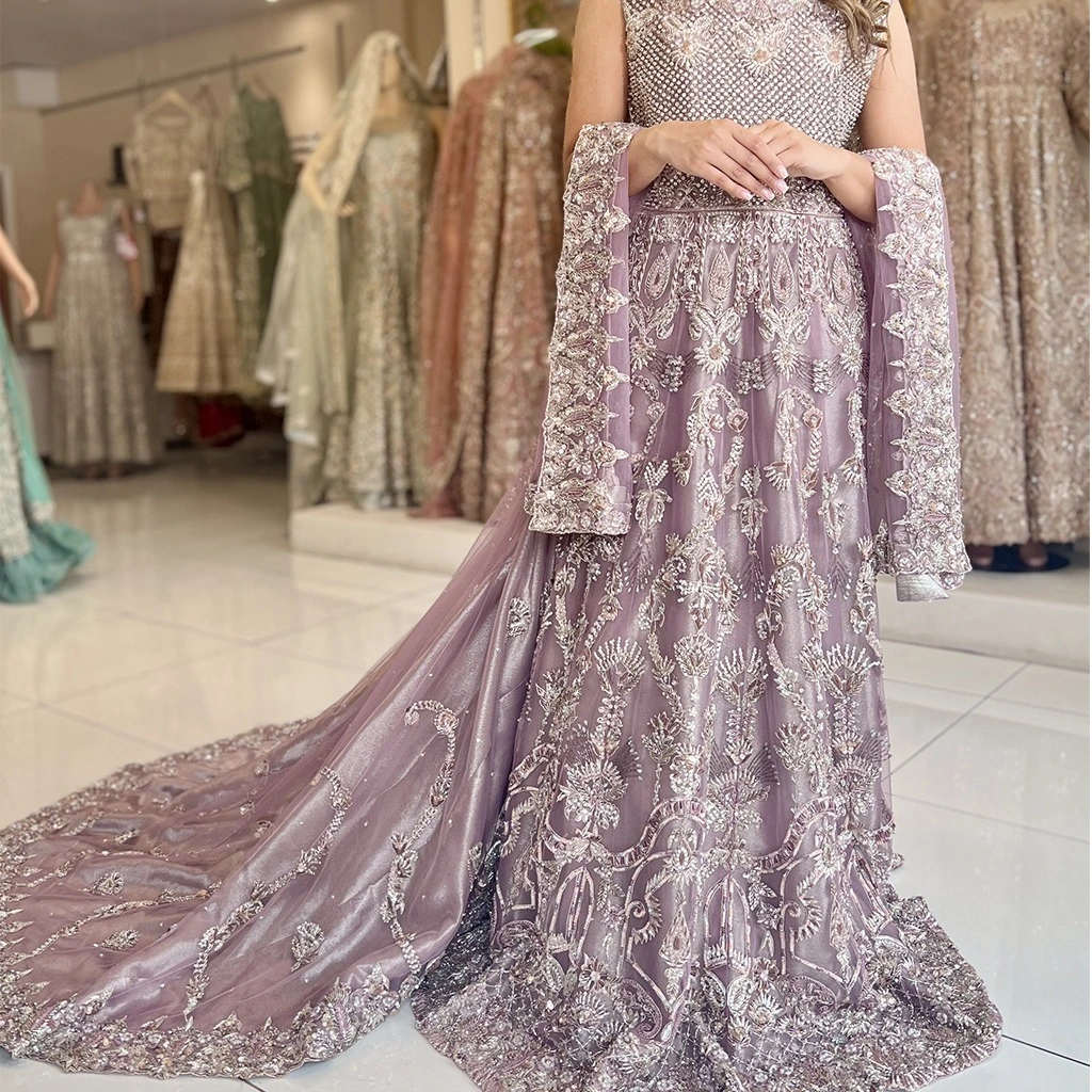 heavily embroidered dress with a long trail