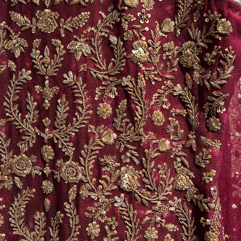 • Macro shots showing resham vines, 3D petals, pearls, and beads in layers. • Include artisan hands embroidering or arranging floral appliqués.