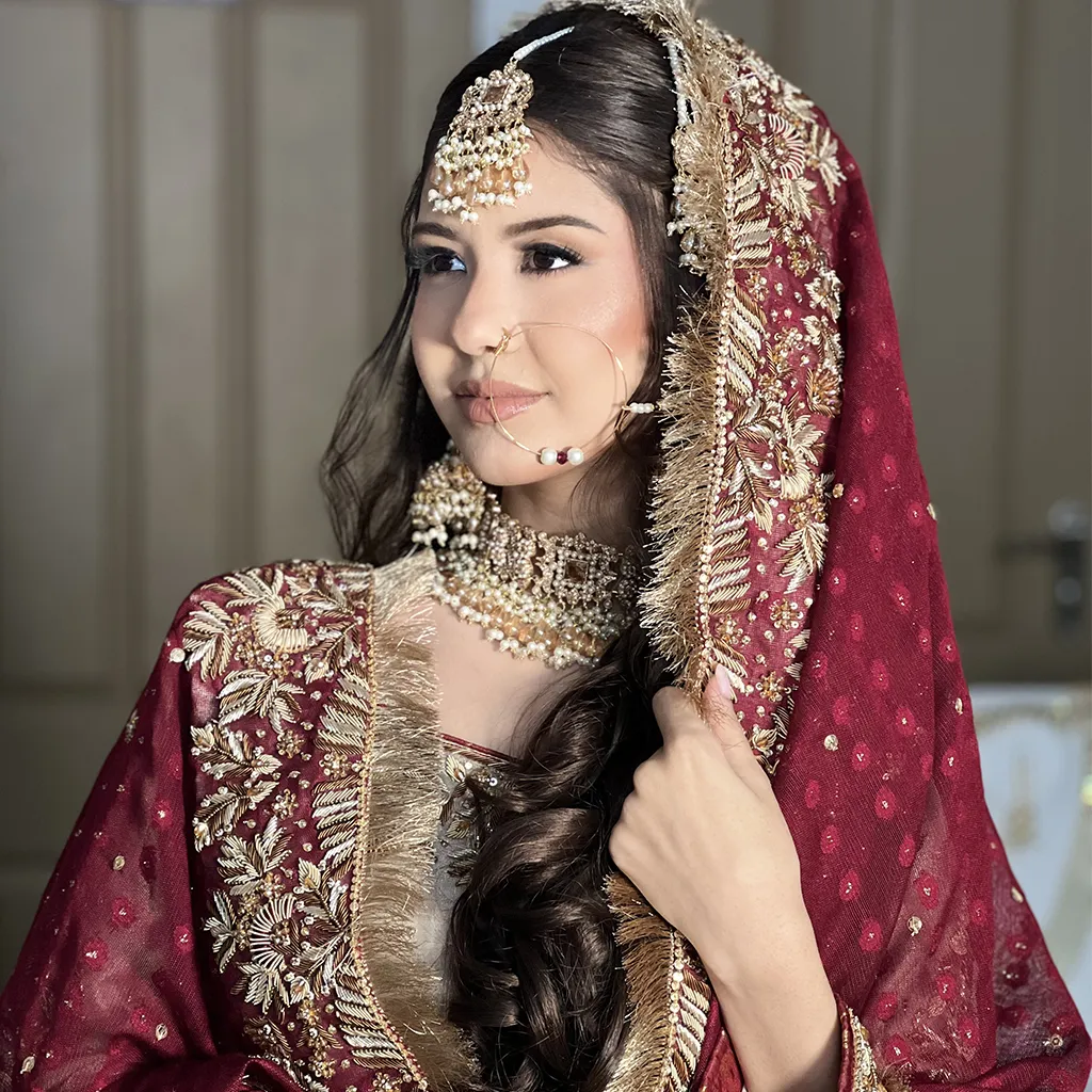 • A collage or full-length shot showing three brides with distinct draping styles: 1. Traditional head-covering dupatta with vintage embroidery. 2. Shoulder-trailing statement dupatta showcasing delicate work. 3. Belted drape for a modern fusion look. • Fabrics: Net, organza, tissue — with zari, dabka, and pearl detailing.