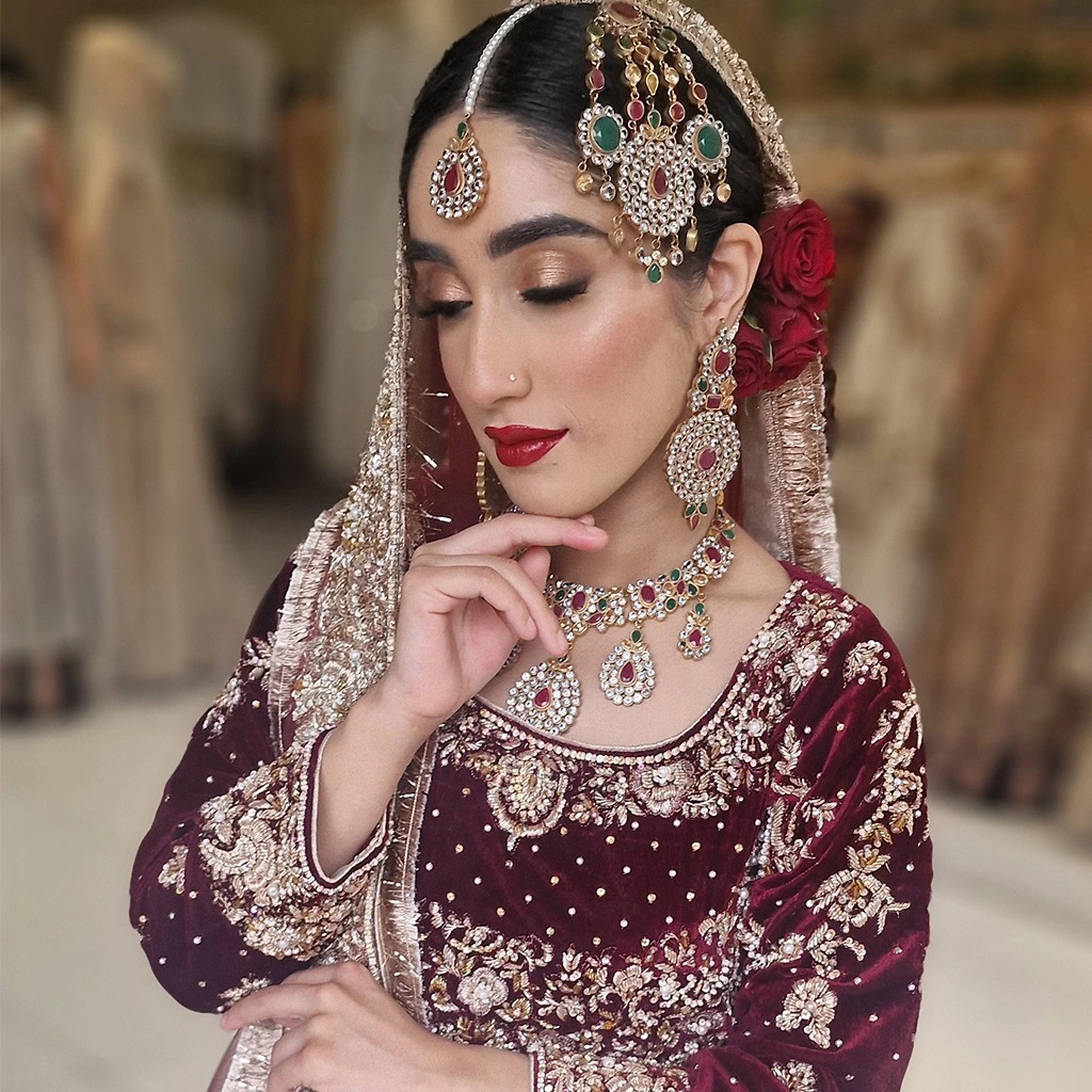 • Close-up of a velvet lehenga or gown with detailed zardozi embroidery. • Optional shot of a bride adjusting her dupatta, showcasing the plush texture.